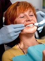 Patient and dentist examining smile in mirror
