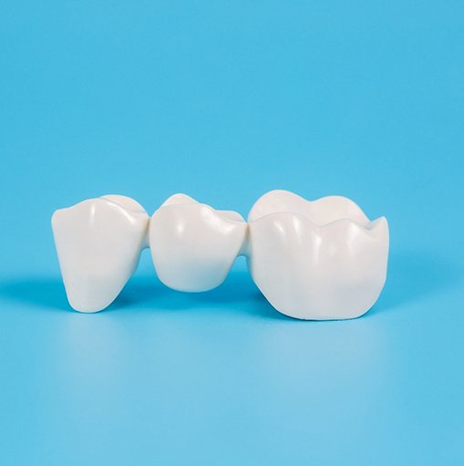 Dental bridge on light blue background