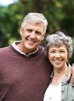 senior man and woman smiling with dental implants in Norwood 
