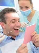 patient smiling while looking in mirror  