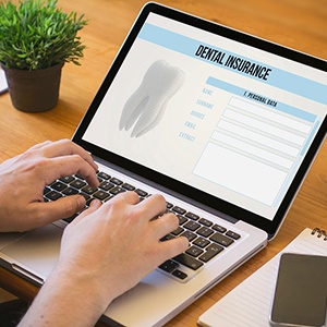 Patient filling out dental insurance form on computer