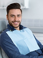 Man sitting in a dental chair and smiling