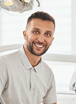 Male patient in a dental chair smiling 