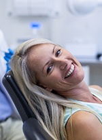 Female dental patient lying back in chair