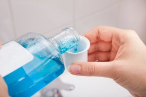 person pouring mouthwash