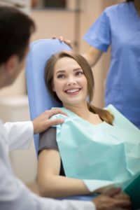 Smiling patient speaking with a dentist in Norwood.