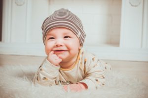 Happy baby sucking on finger