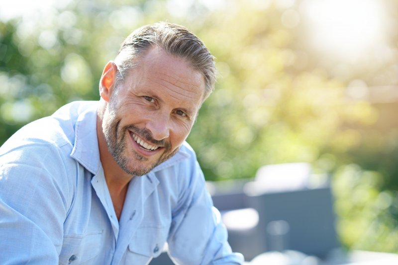 man smiling after cosmetic dentistry in Norwood