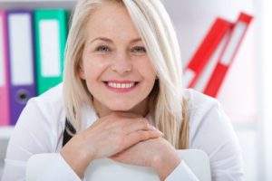 Older woman with dental implants smiling