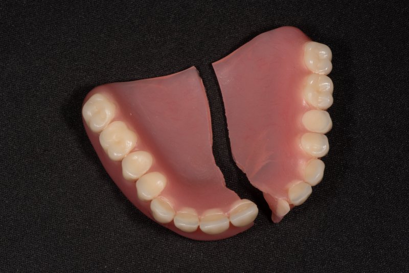 A set of dentures that have split in two