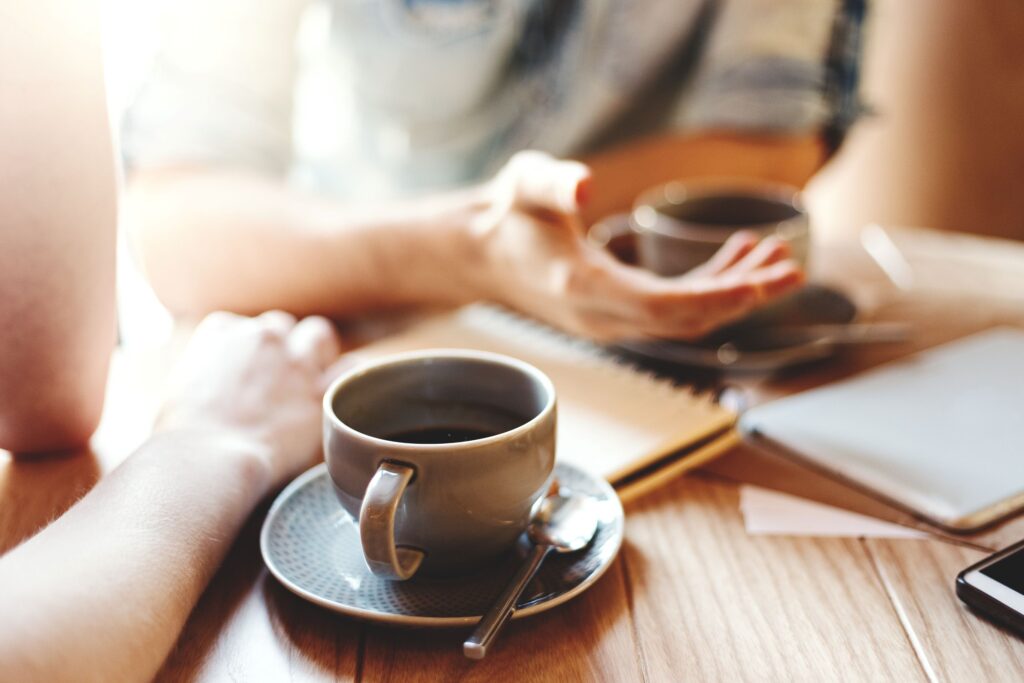 Two people chatting over coffee
