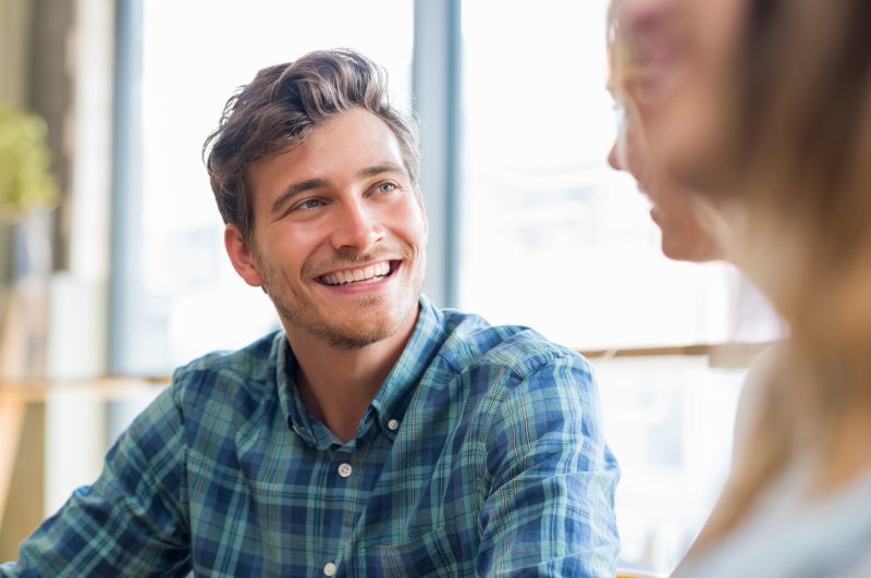 Patient smiling at dentist during cosmetic dentistry treatment